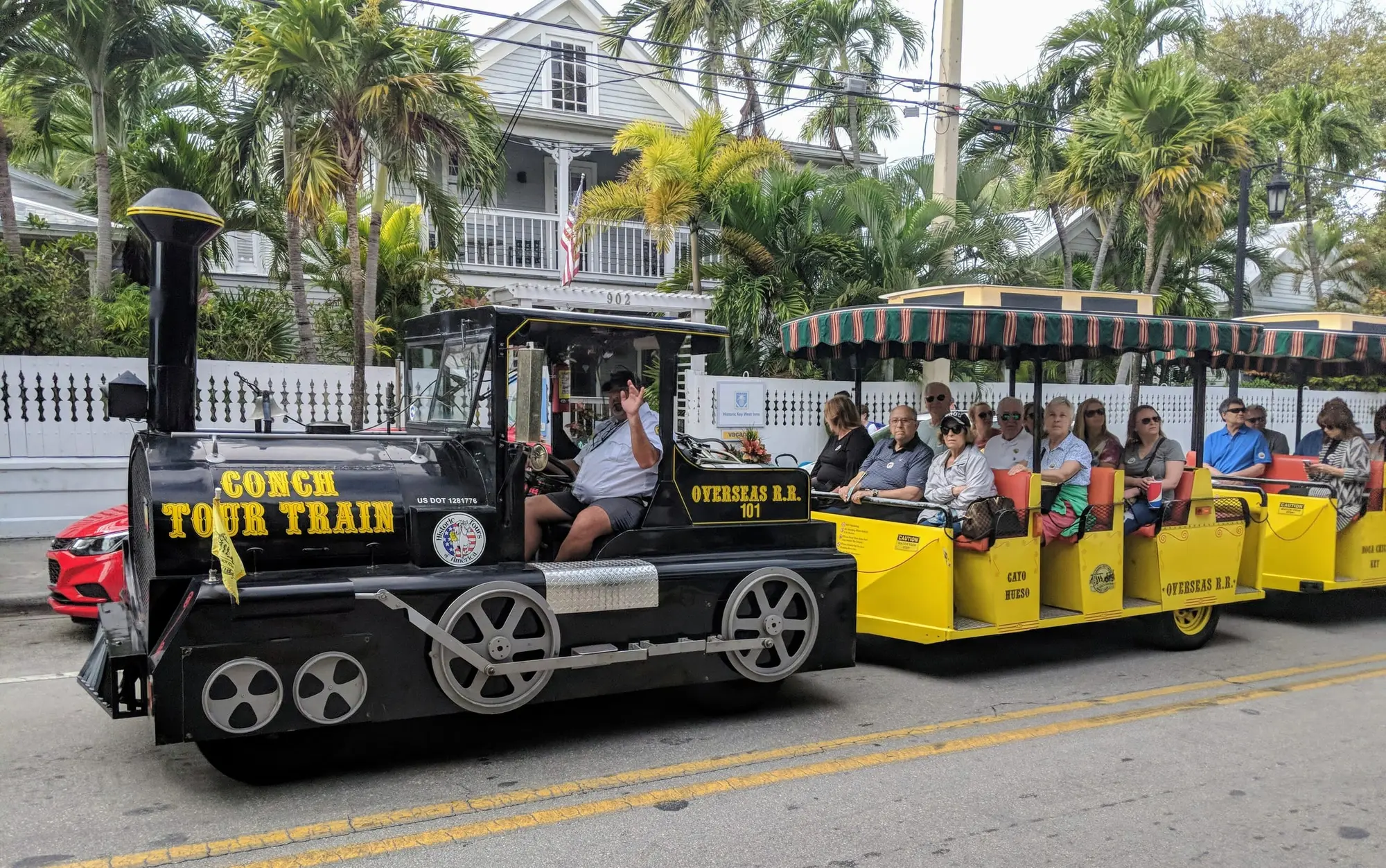 The Conch Tour Train on a Key West street, its open cars full of passengers