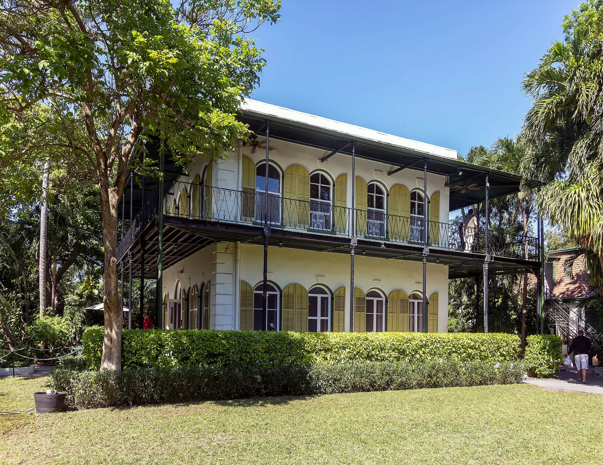 The Ernest Hemingway House in Key West, its two-story veranda behind palms