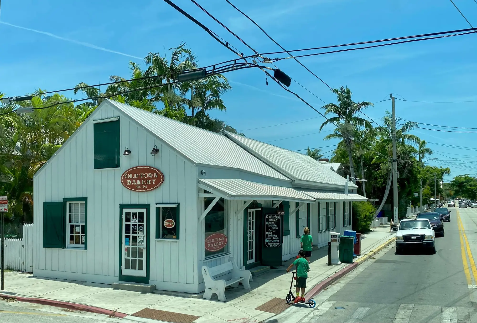 A street corner in Key West's Old Town, cars parked along the curb